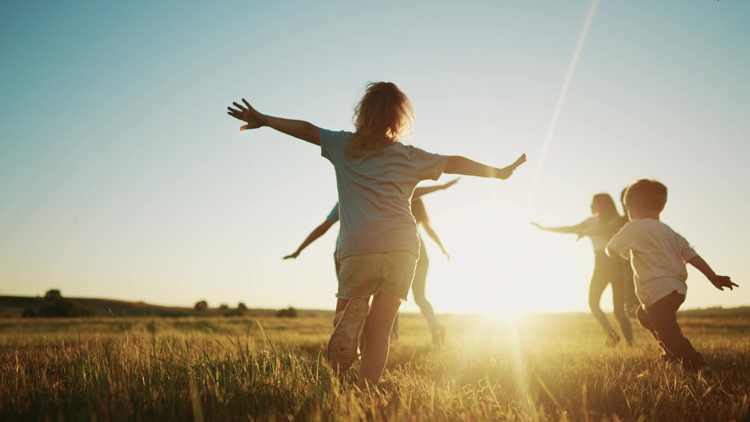 kids run in the park at sunset. friendly family children camp kid dream concept. group of children run on the grass at fun the rays of the sun silhouette. childhood sunset dream teamwork concept